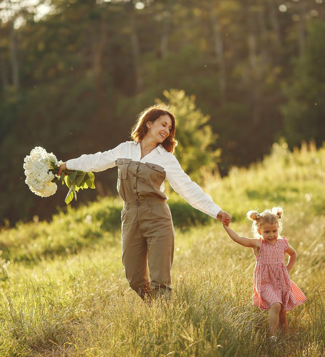 Family in the fields beside Dreamfields, a new home community in Bradford West Gwillimbury on the Holland River